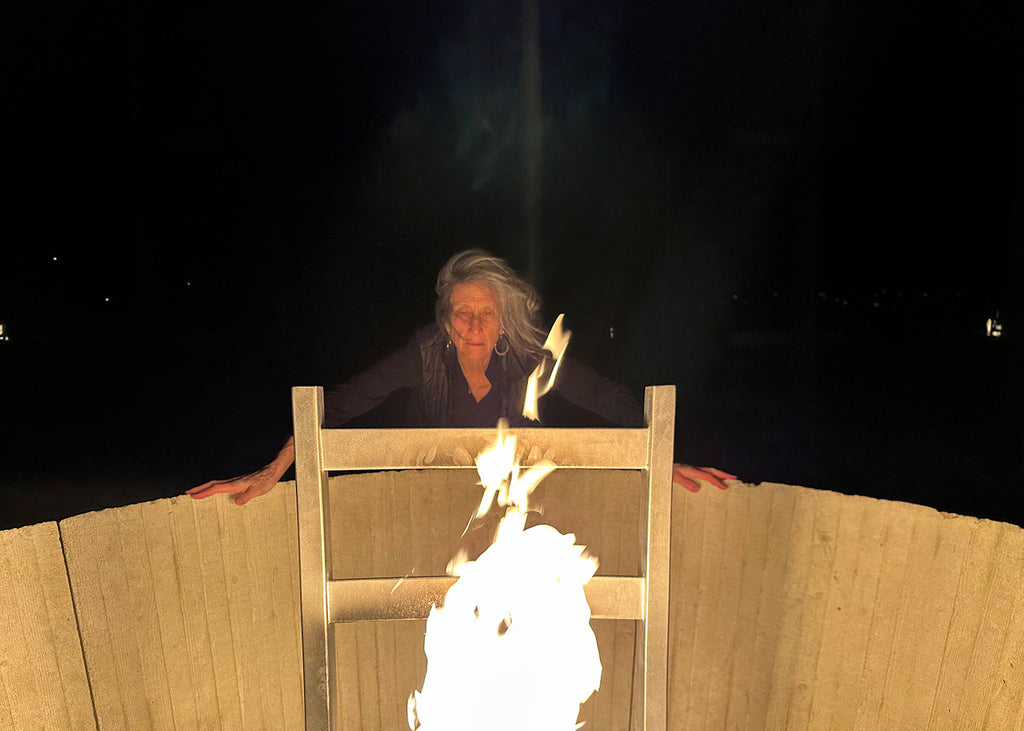 Liz Lerman with the perpetual flame at the Steilneset Memorial in Vardø, Norway, north of the Arctic Circle (2023). Photograph by Anna Spelman